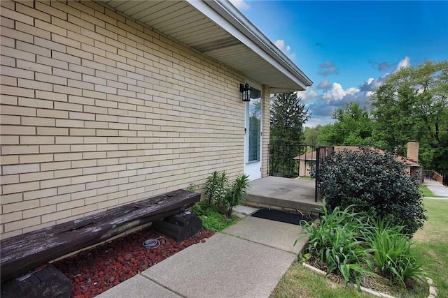 view of side of property featuring brick siding