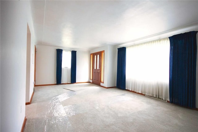 carpeted spare room with baseboards
