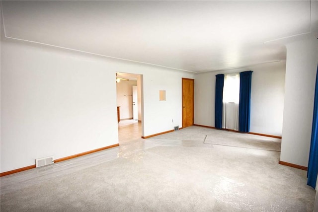 spare room with carpet and baseboards