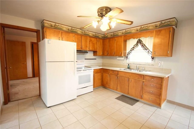 kitchen featuring white appliances, under cabinet range hood, light countertops, a sink, and a ceiling fan
