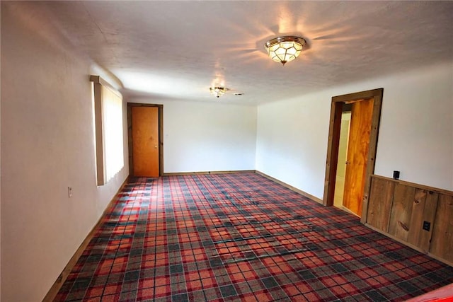 unfurnished room featuring carpet