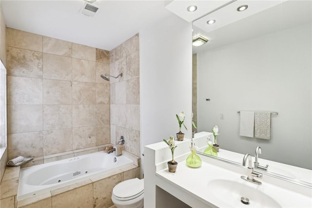 full bath featuring a combined bath / shower with jetted tub, toilet, recessed lighting, and vanity