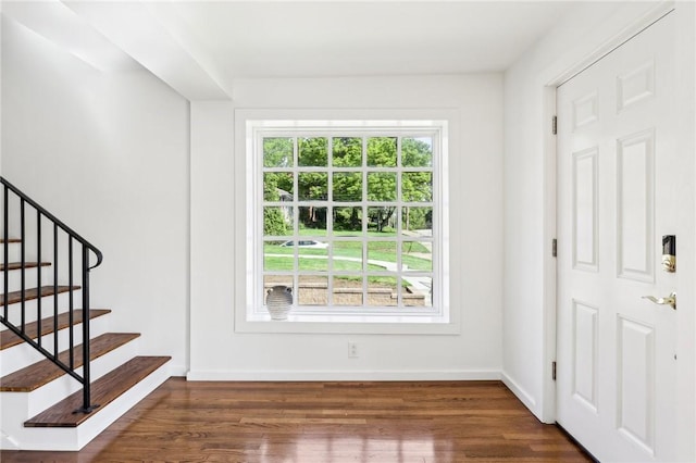 entrance foyer featuring wood finished floors, baseboards, and stairway
