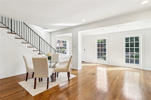 dining space featuring plenty of natural light, wood finished floors, recessed lighting, and baseboards