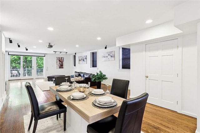 dining space with recessed lighting and light wood finished floors