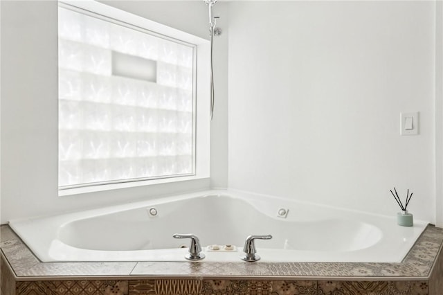 bathroom featuring a tub with jets