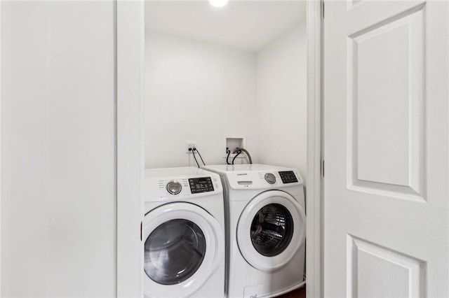 laundry area featuring washing machine and clothes dryer