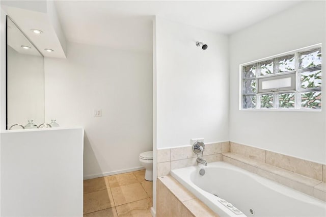 full bathroom featuring a garden tub, toilet, and tile patterned floors