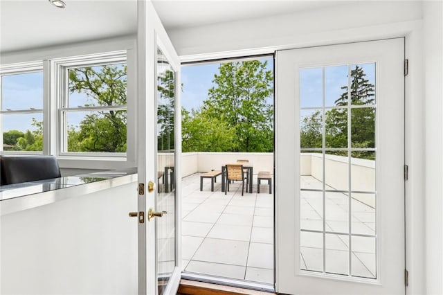 doorway to outside featuring tile patterned flooring