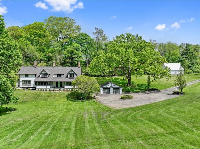 view of grassy yard with an outbuilding and a detached garage