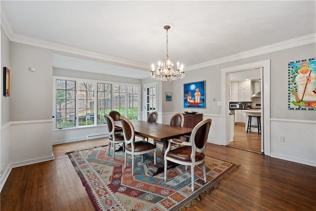 dining space featuring a chandelier, hardwood / wood-style floors, crown molding, and a baseboard radiator