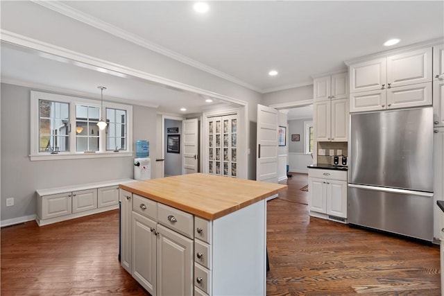 kitchen featuring stainless steel refrigerator, butcher block countertops, recessed lighting, white cabinetry, and dark wood-type flooring