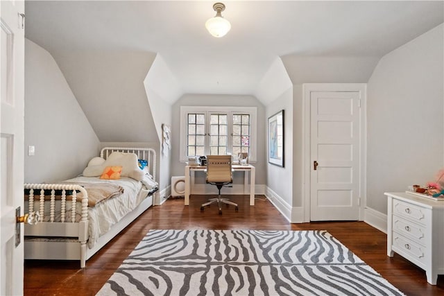 bedroom featuring vaulted ceiling, wood finished floors, and baseboards