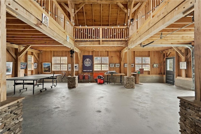 miscellaneous room with concrete floors and wooden walls