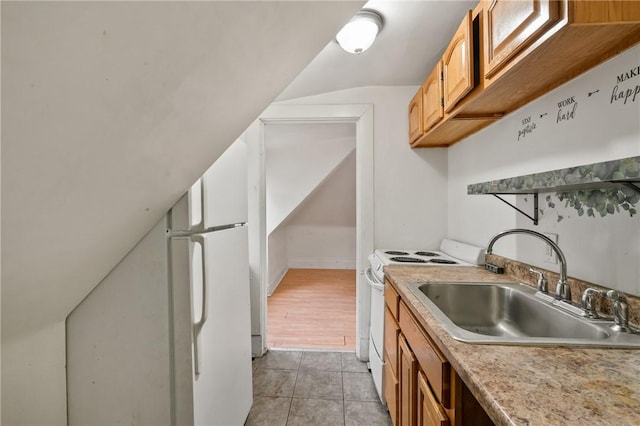 1608 Union Ave, Mckeesport, PA 15132 - kitchen featuring a sink, white electric range, light countertops, light tile patterned flooring, and vaulted ceiling