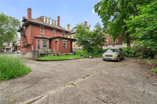 1608 Union Ave, Mckeesport, PA 15132 - rear view of property featuring brick siding and a chimney