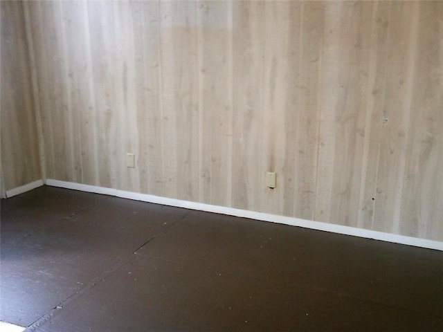 spare room with baseboards