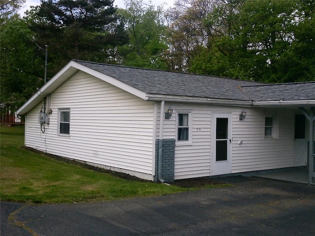 view of home's exterior featuring roof with shingles