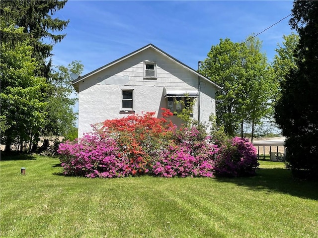 view of property exterior with a yard