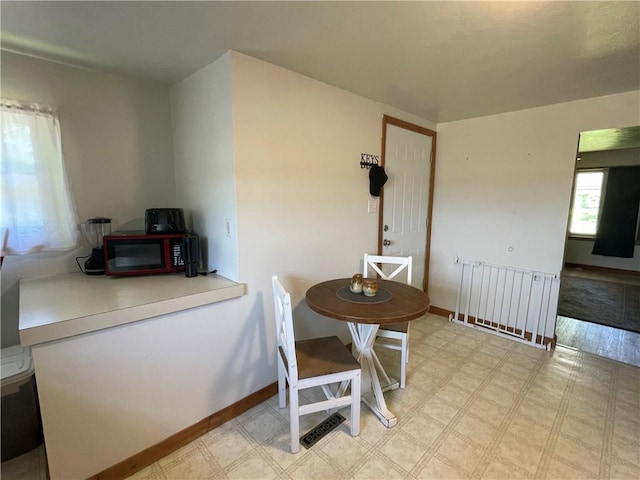 dining space with light flooring and baseboards