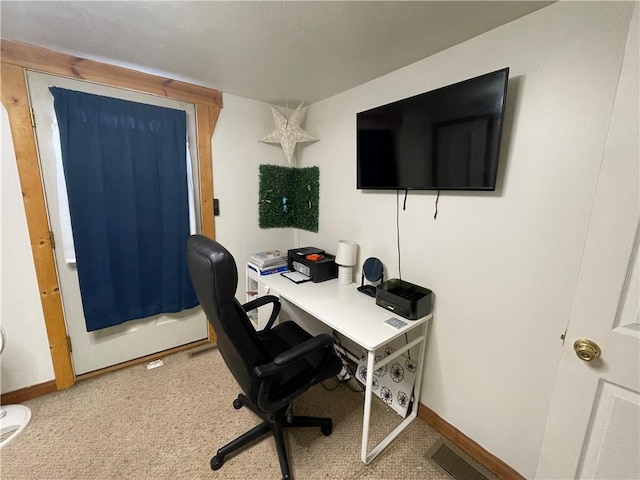 carpeted home office with baseboards