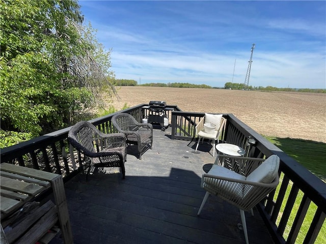 wooden terrace featuring a view of rural / pastoral area