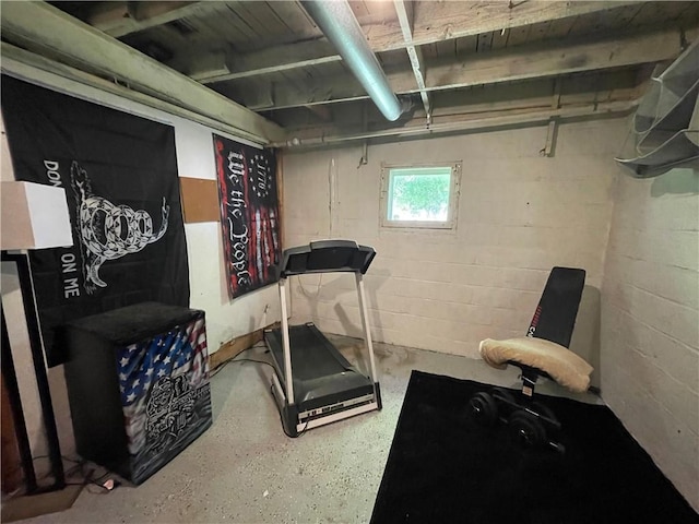 exercise area featuring concrete block wall