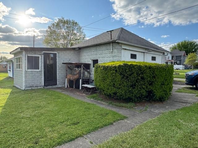 rear view of property with a yard