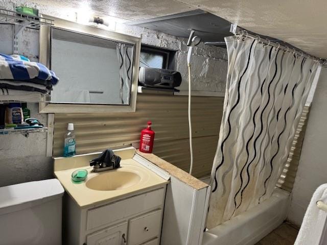 bathroom featuring vanity, shower / tub combo with curtain, and toilet