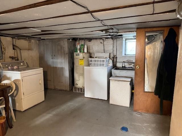 basement featuring water heater and washer and clothes dryer