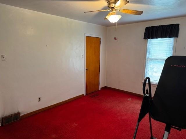 office area with carpet floors, ceiling fan, and baseboards