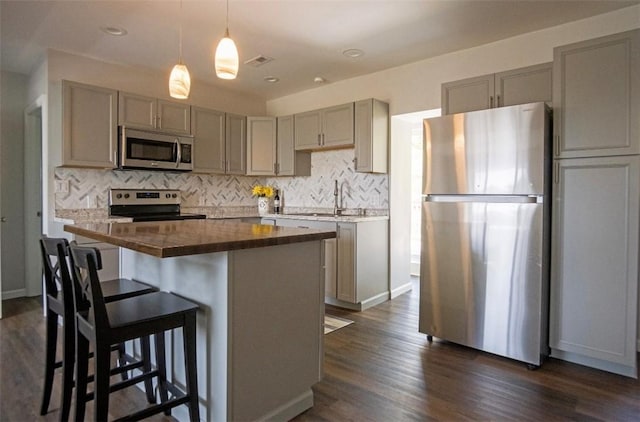 1435 Orchard St, New Sewickley Twp, PA 15042 - kitchen featuring stainless steel appliances, gray cabinets, backsplash, a sink, and dark wood finished floors