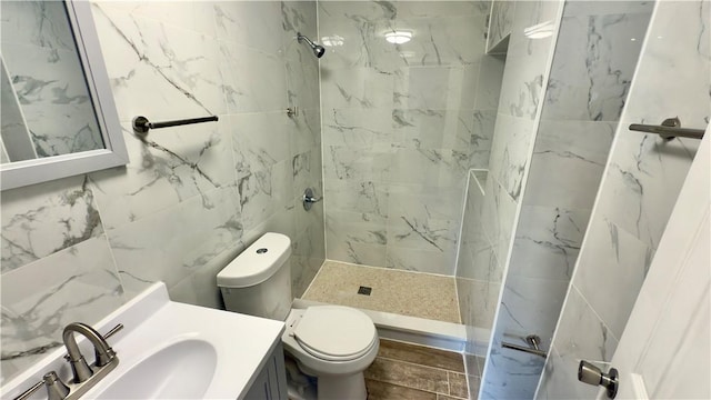 3902 Liberty Ave, Bloomfield, PA 15224 - bathroom featuring a tile shower, toilet, and vanity