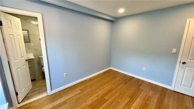 3902 Liberty Ave, Bloomfield, PA 15224 - unfurnished bedroom with light wood-style flooring, baseboards, recessed lighting, and connected bathroom