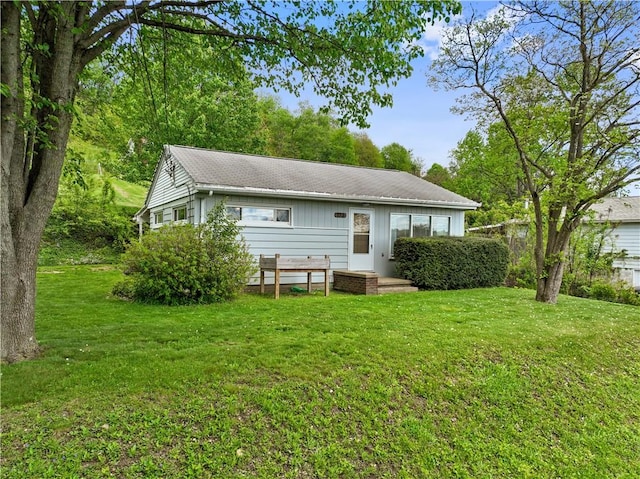 back of property featuring a lawn