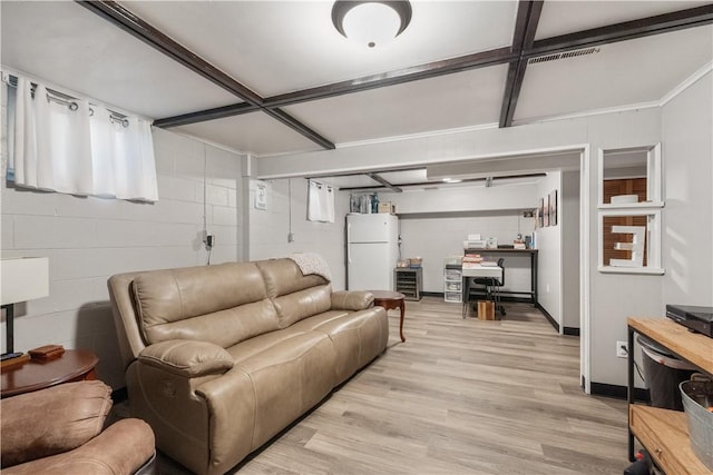 living area with light wood finished floors, concrete block wall, and coffered ceiling