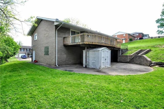rear view of house featuring stairway, a storage shed, an outdoor structure, a wooden deck, and a lawn