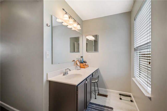 bathroom with baseboards and vanity