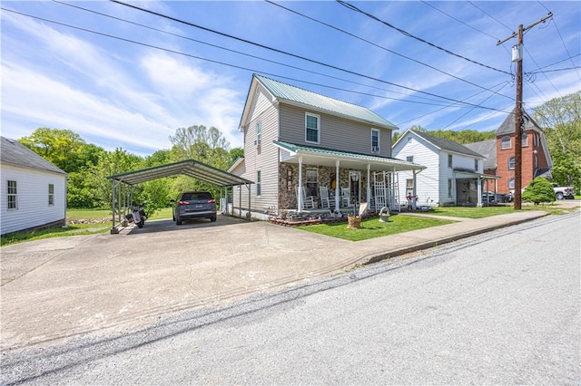 135 Oak Forest Rd, New Freeport, PA 15316 - view of front of home with a carport, driveway, covered porch, and metal roof