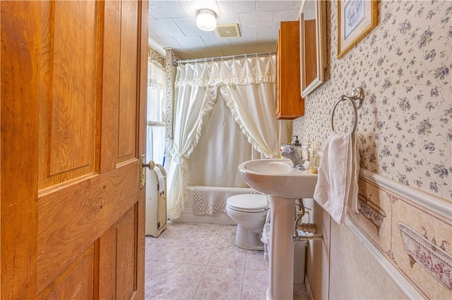 135 Oak Forest Rd, New Freeport, PA 15316 - bathroom with wallpapered walls, toilet, tile patterned flooring, and shower / bathtub combination with curtain