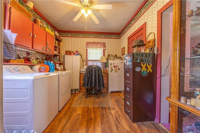 135 Oak Forest Rd, New Freeport, PA 15316 - laundry area with independent washer and dryer, wallpapered walls, ceiling fan, wood finished floors, and cabinet space