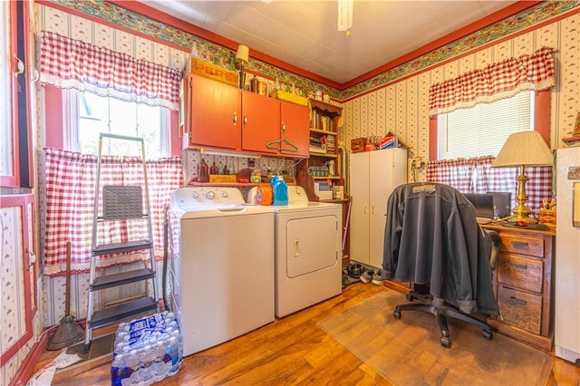 135 Oak Forest Rd, New Freeport, PA 15316 - laundry room with washing machine and dryer, wallpapered walls, cabinet space, and wood finished floors