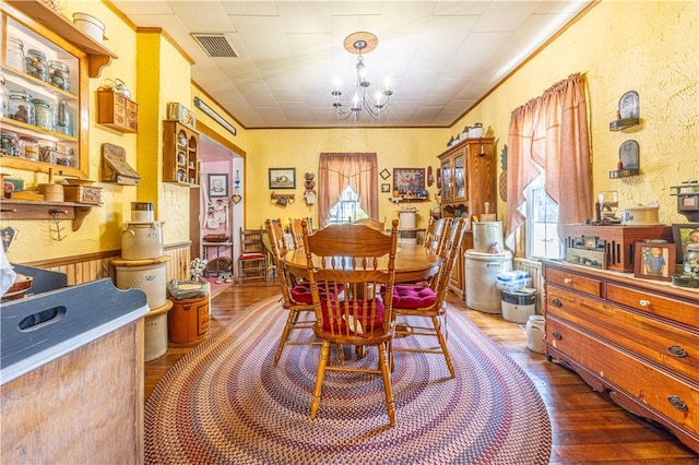 135 Oak Forest Rd, New Freeport, PA 15316 - dining space with a chandelier, wood finished floors, and wainscoting