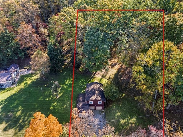 view from above of property featuring property boundaries highlighted and a forest