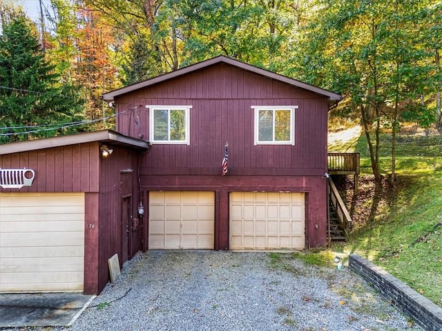 view of front of house featuring a detached garage and stairway