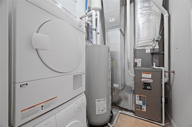 utilities with stacked washer and clothes dryer, electric water heater, and heating unit