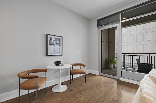 living area featuring wood finished floors and baseboards