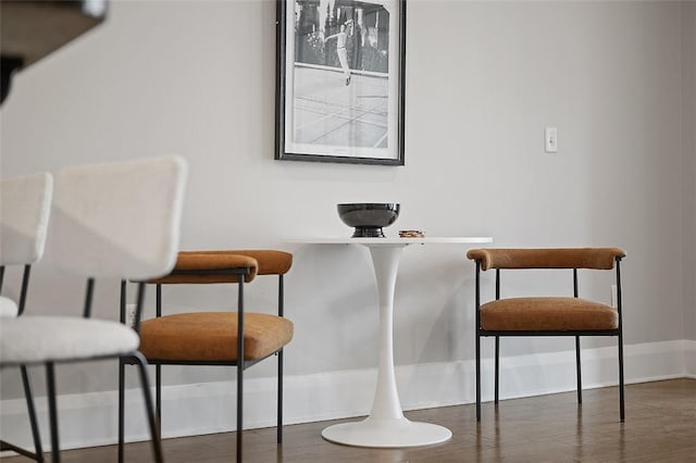 dining room with baseboards and wood finished floors