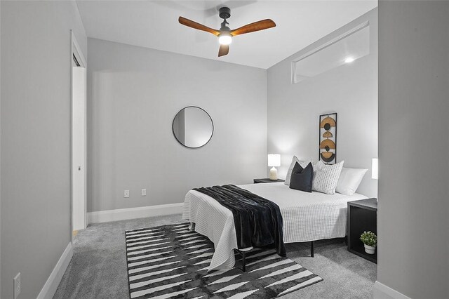 carpeted bedroom with baseboards and ceiling fan