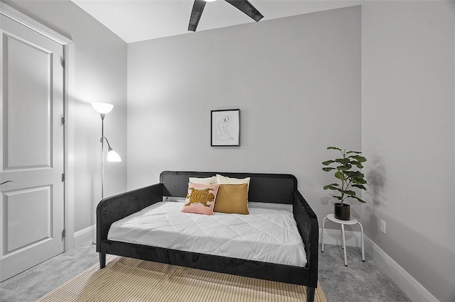 bedroom featuring carpet and baseboards